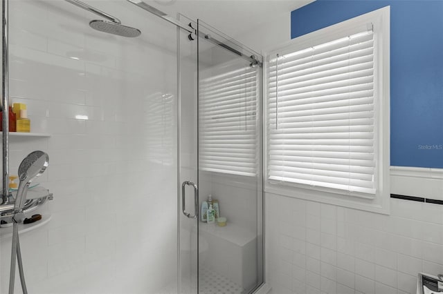 bathroom featuring tile walls and walk in shower