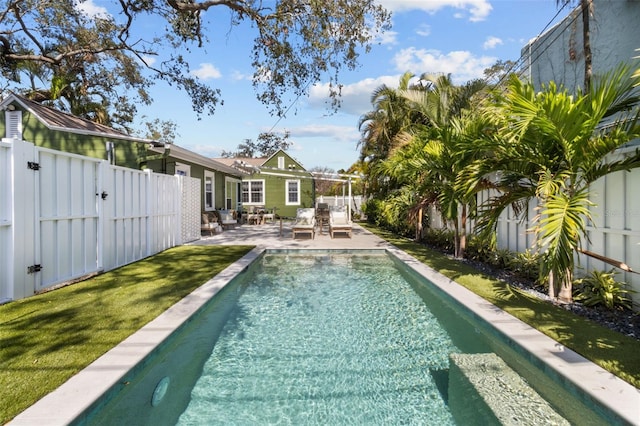 view of swimming pool featuring a yard and a patio area