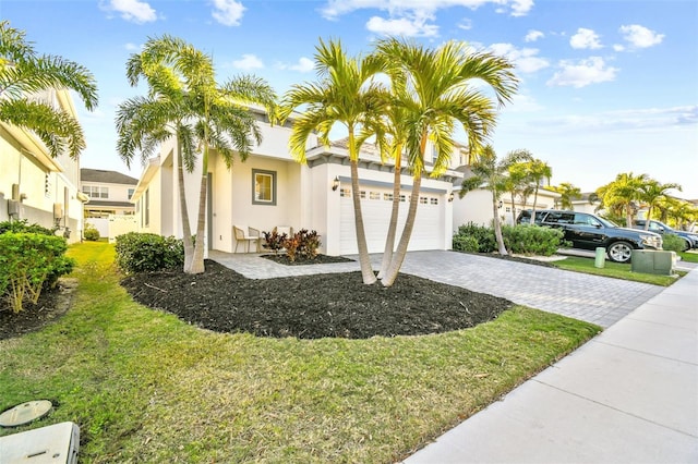 view of front of home featuring a garage and a front yard