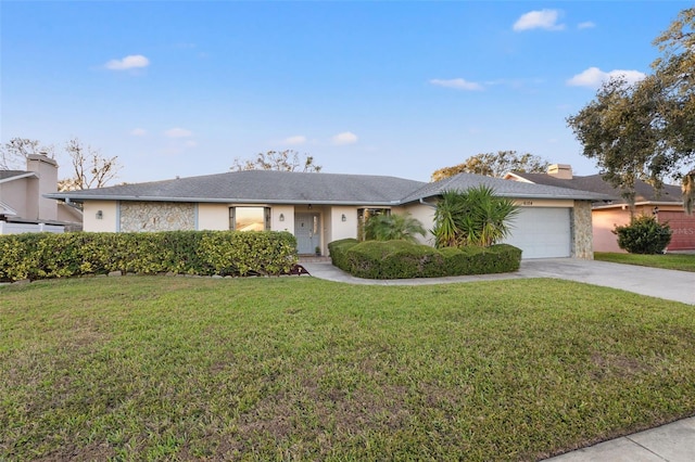 ranch-style house with a garage and a front lawn