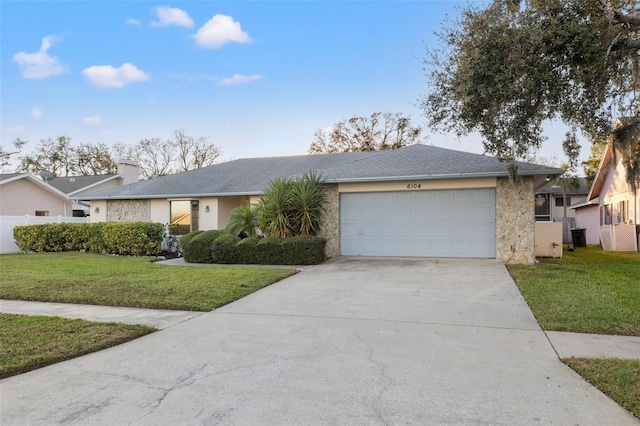 single story home featuring a garage and a front lawn