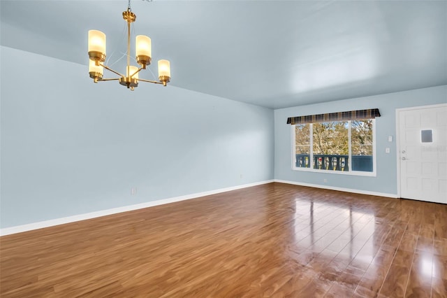 interior space with hardwood / wood-style floors and an inviting chandelier