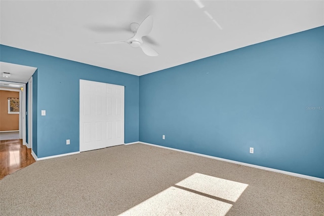 unfurnished bedroom with carpet, ceiling fan, and a closet