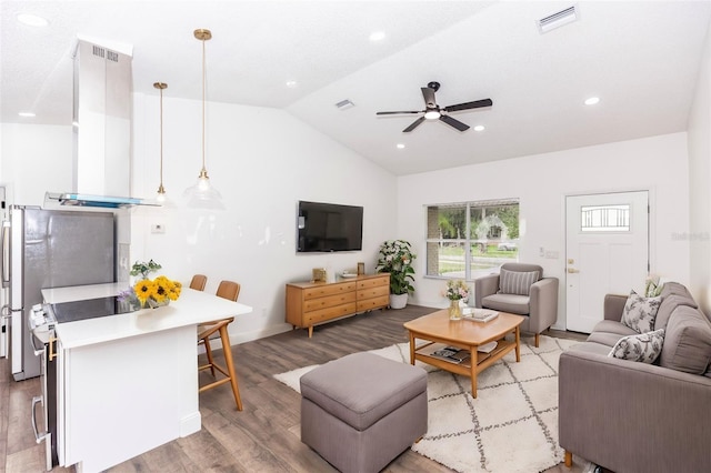 living room featuring ceiling fan, lofted ceiling, and light wood-type flooring