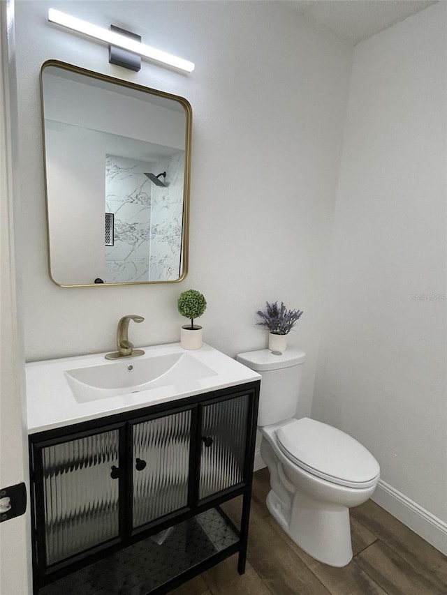 bathroom with vanity, hardwood / wood-style floors, and toilet