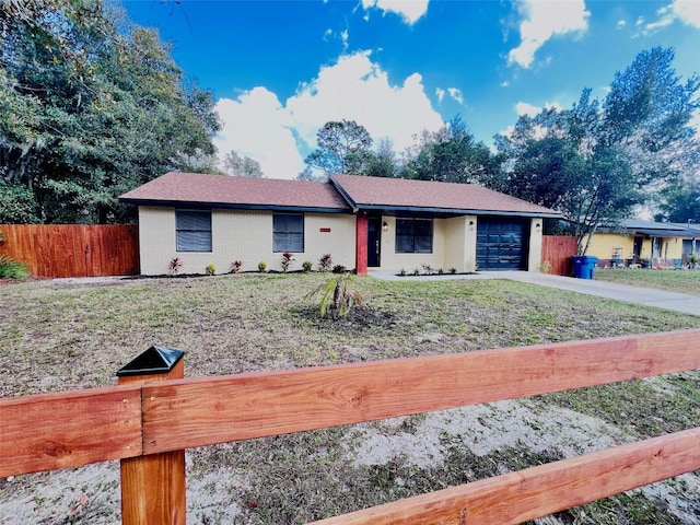 single story home with a garage and a front yard