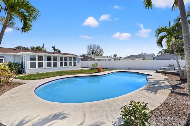 view of swimming pool featuring a sunroom