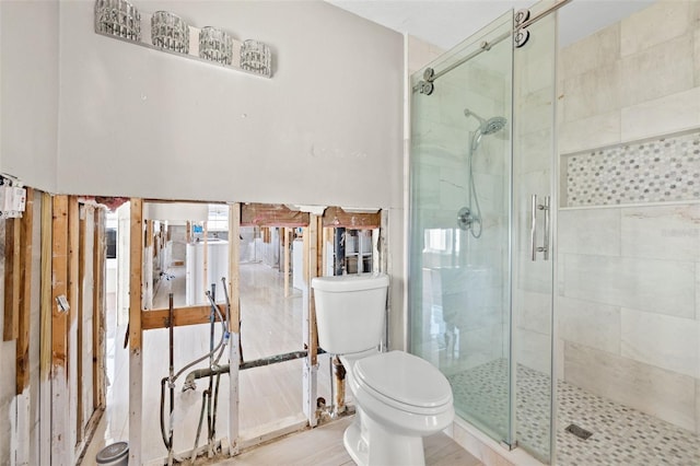 bathroom with walk in shower and toilet