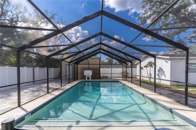 view of swimming pool with a lanai and a patio