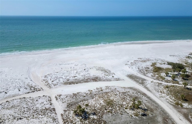 bird's eye view with a water view and a beach view