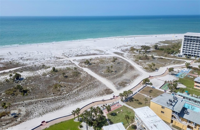 drone / aerial view featuring a water view and a view of the beach