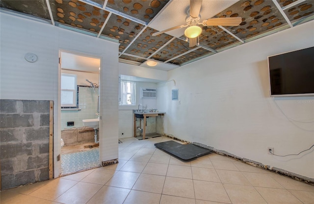 interior space featuring tile patterned floors, a wall mounted AC, and ceiling fan