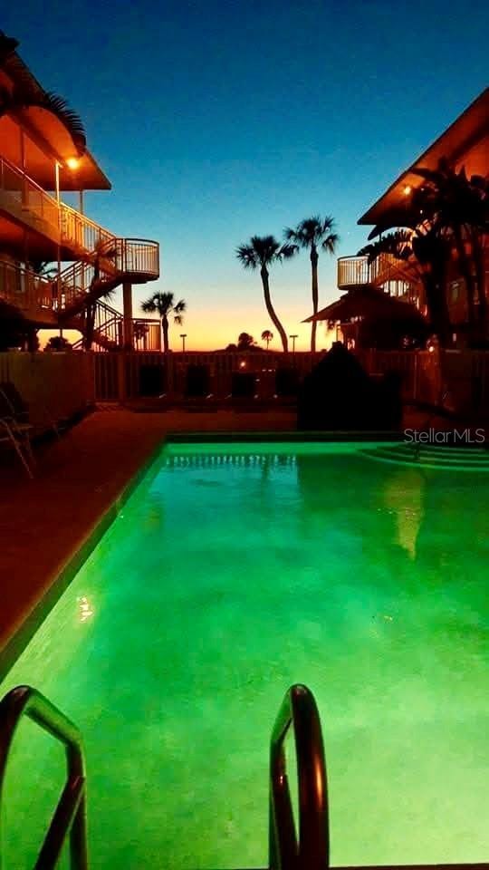 view of pool at dusk