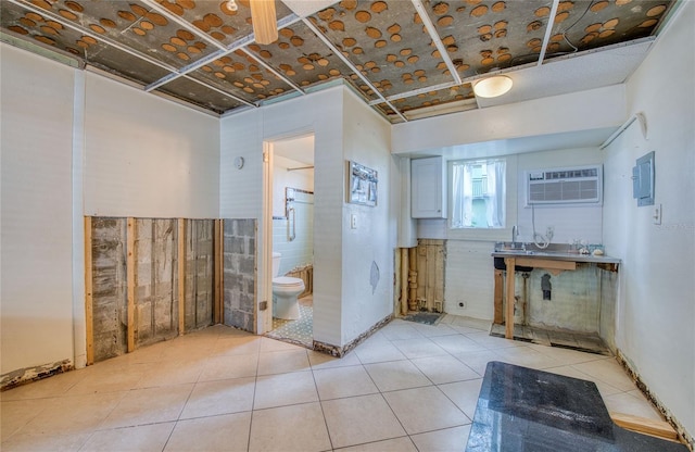 bathroom with a wall mounted air conditioner, tile patterned floors, tile walls, and toilet