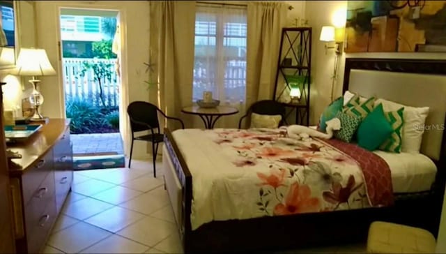 tiled bedroom with multiple windows