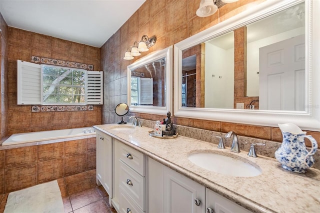 2786 Countryside Blvd Unit 2, Clearwater, FL 33761 - bathroom with a relaxing tiled tub, tile patterned floors, vanity, and tile walls