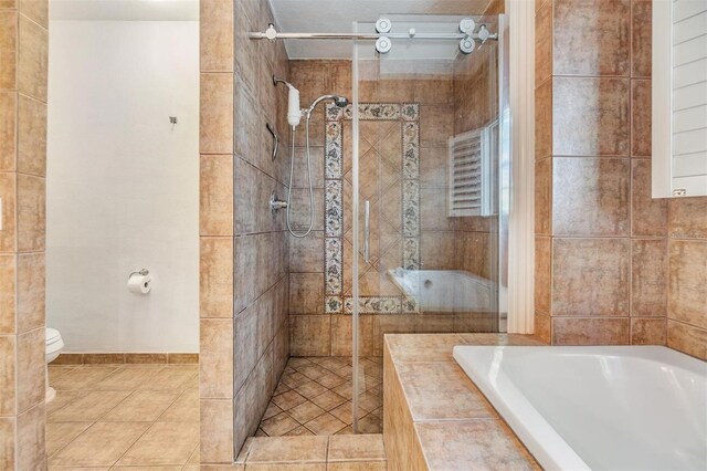 2786 Countryside Blvd Unit 2, Clearwater, FL 33761 - bathroom with separate shower and tub, tile patterned floors, and toilet