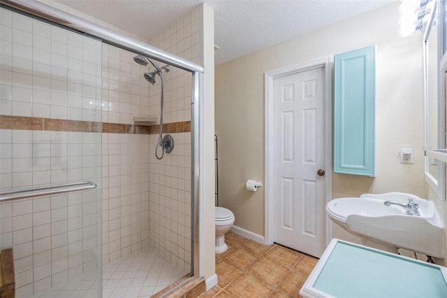 2786 Countryside Blvd Unit 2, Clearwater, FL 33761 - bathroom featuring an enclosed shower, sink, tile patterned floors, and toilet