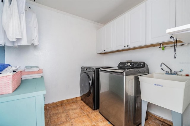 2786 Countryside Blvd Unit 2, Clearwater, FL 33761 - laundry room with sink, light tile patterned floors, washing machine and dryer, cabinets, and ornamental molding