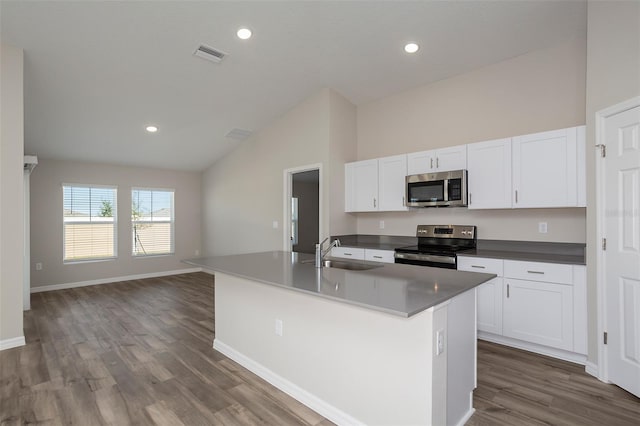 kitchen featuring dark hardwood / wood-style floors, an island with sink, white cabinetry, sink, and stainless steel appliances