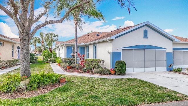 ranch-style house with concrete driveway, an attached garage, a front yard, and stucco siding