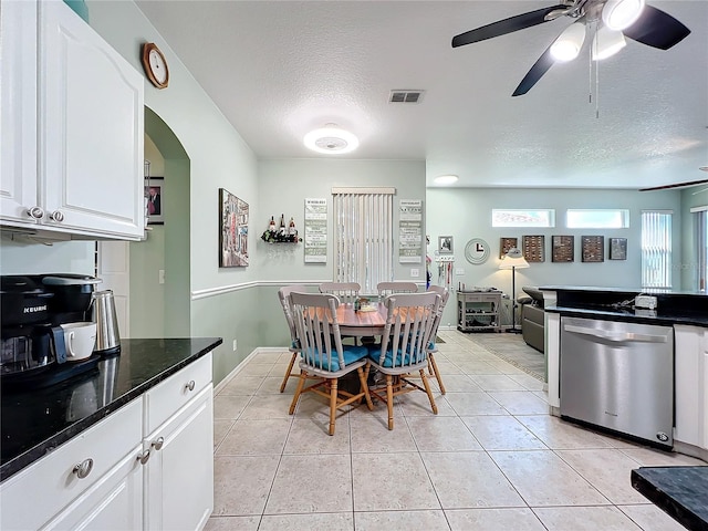 dining space with visible vents, ceiling fan, light tile patterned floors, arched walkways, and a textured ceiling
