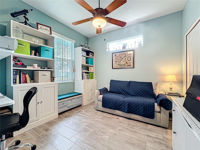 home office featuring a textured ceiling, a ceiling fan, and wood finish floors