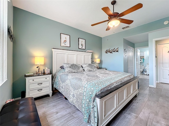 bedroom with visible vents, baseboards, light wood-style floors, and a ceiling fan