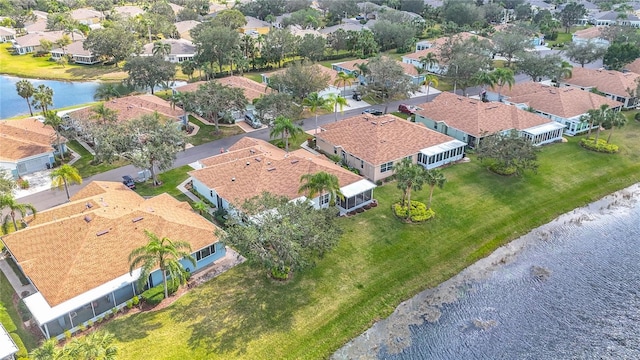 bird's eye view with a residential view and a water view
