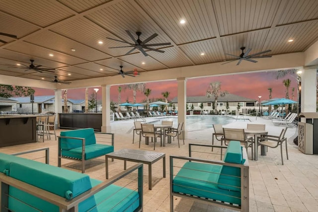 view of patio with outdoor dry bar and ceiling fan