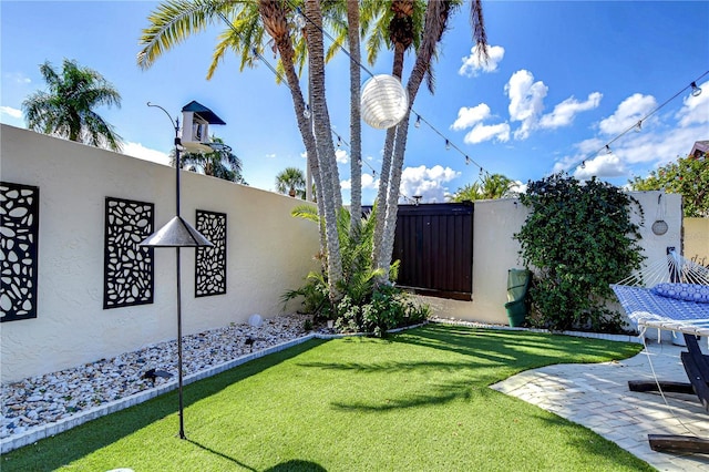 view of yard featuring a patio area and fence