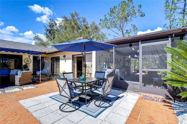 view of patio featuring an outdoor living space, outdoor dining area, and a sunroom