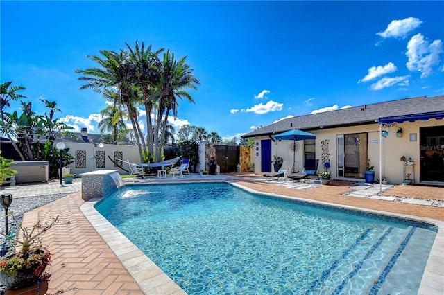 view of swimming pool featuring a fenced in pool, a patio area, and fence