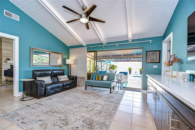 living area featuring a wealth of natural light, tile patterned flooring, visible vents, and lofted ceiling with beams