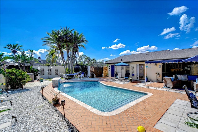 view of swimming pool featuring fence, outdoor lounge area, a fenced in pool, and a patio