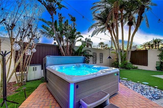 view of pool with a yard, a patio, a fenced backyard, and a hot tub