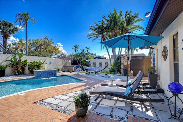 view of pool featuring a fenced in pool, a fenced backyard, a storage unit, an outdoor structure, and a patio area