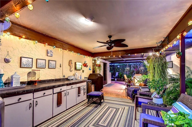 view of patio / terrace with exterior kitchen, ceiling fan, grilling area, and an outdoor hangout area