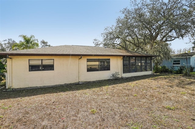 view of side of property featuring a yard and stucco siding