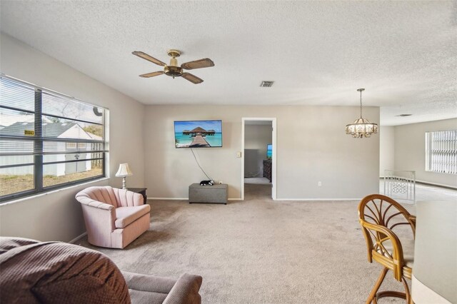 living area with light colored carpet, visible vents, and plenty of natural light