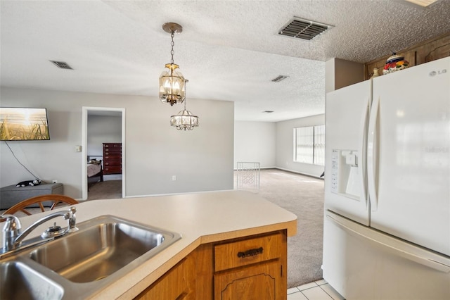 kitchen featuring white fridge with ice dispenser, visible vents, a sink, and light carpet