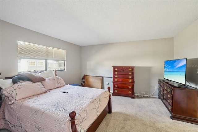 bedroom featuring light carpet and a textured ceiling