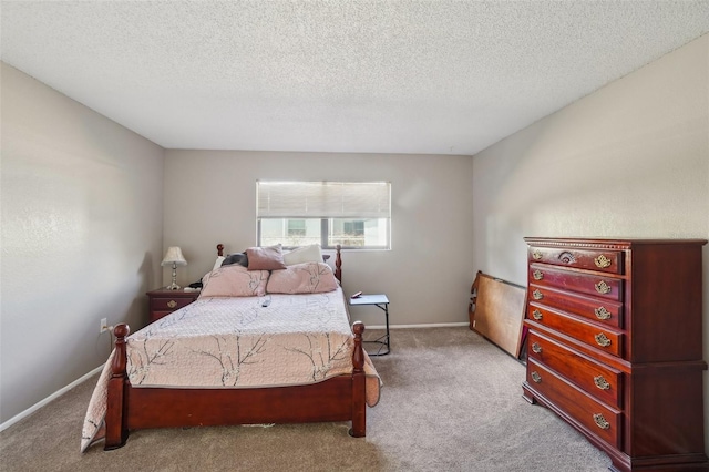 carpeted bedroom with a textured ceiling and baseboards