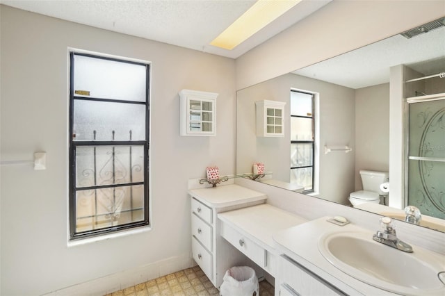 bathroom featuring visible vents, toilet, tile patterned floors, an enclosed shower, and vanity