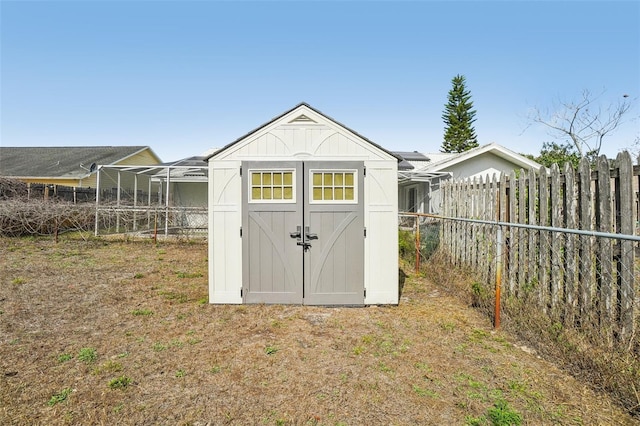 view of shed with fence