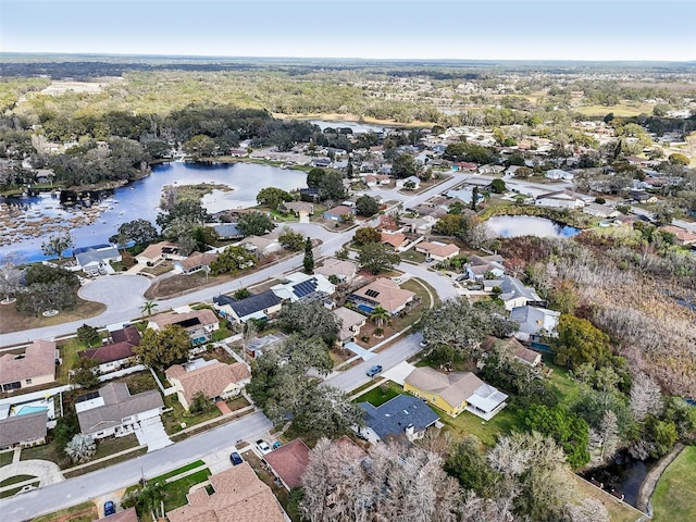 drone / aerial view featuring a residential view and a water view