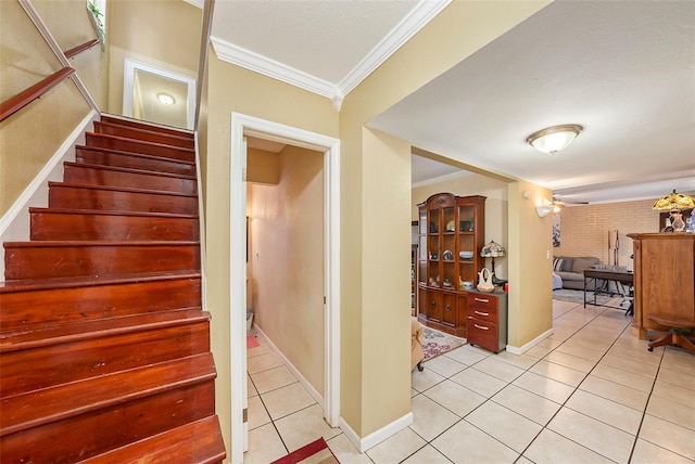 staircase featuring ornamental molding and tile patterned floors