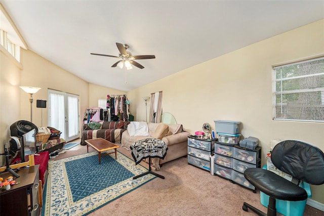 carpeted living room with vaulted ceiling, french doors, and ceiling fan