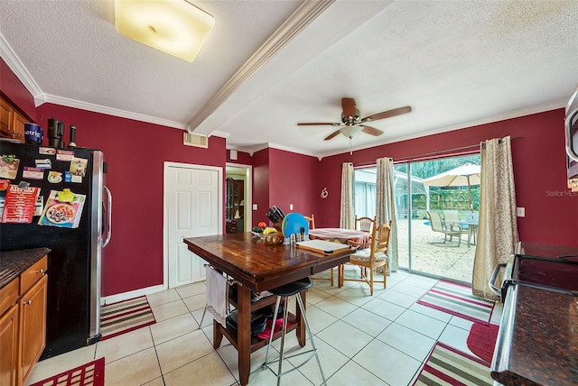 dining space featuring crown molding, light tile patterned flooring, and a textured ceiling