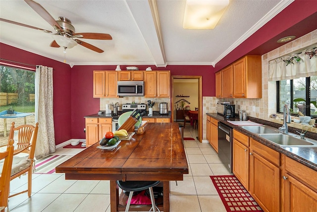 kitchen featuring stainless steel appliances, sink, light tile patterned floors, and decorative backsplash